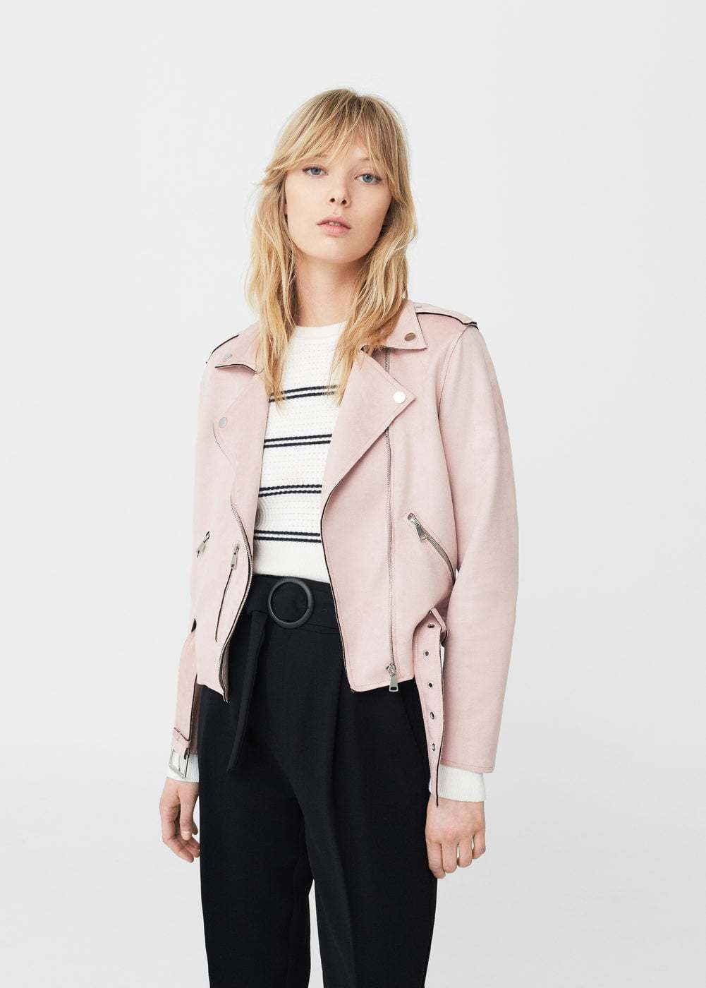 Image of a woman wearing a pink leather jacket for an article about how to wear pink in spring