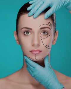 anti-ageing image of a woman with surgery lines drawn on her face for a box about anti-ageing surgeries