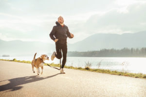 man jogging with dog