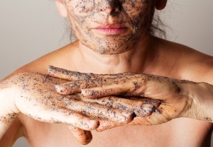 An image of a woman using an exfoliator.