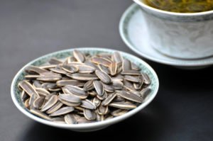 An image of sunflower seeds in a saucer.
