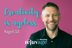 An image of Nigel smiling in front of a pink background with the quote superimposed, 'creativity is ageless'.