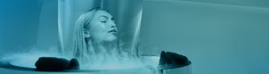 An image of a woman having cyrotherapy with a blue tint.