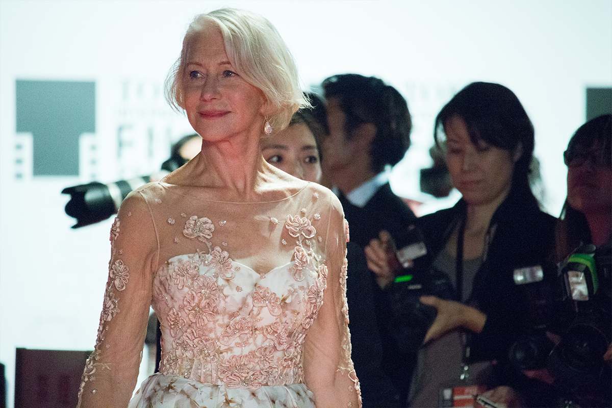 An image of the age amazing Helen Mirren in an elegant white dress.