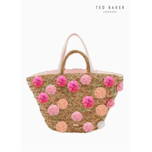 An image of a summer beach bag with pink and orange pom poms on it.