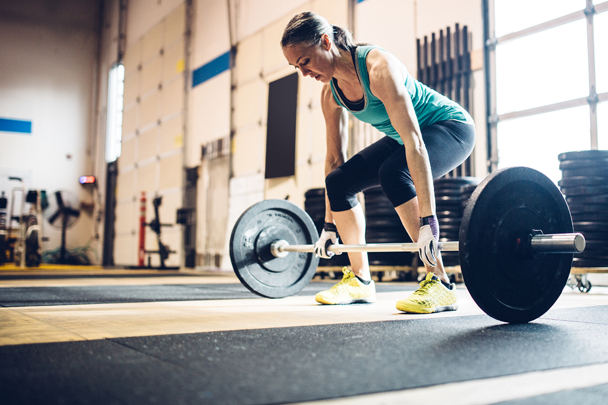 An image of a midster strength exercising, deadlifting a barbell.