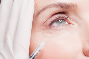 A close up image of a mature woman getting the anti-ageing treatment botox to reduce the appearance of wrinkles.