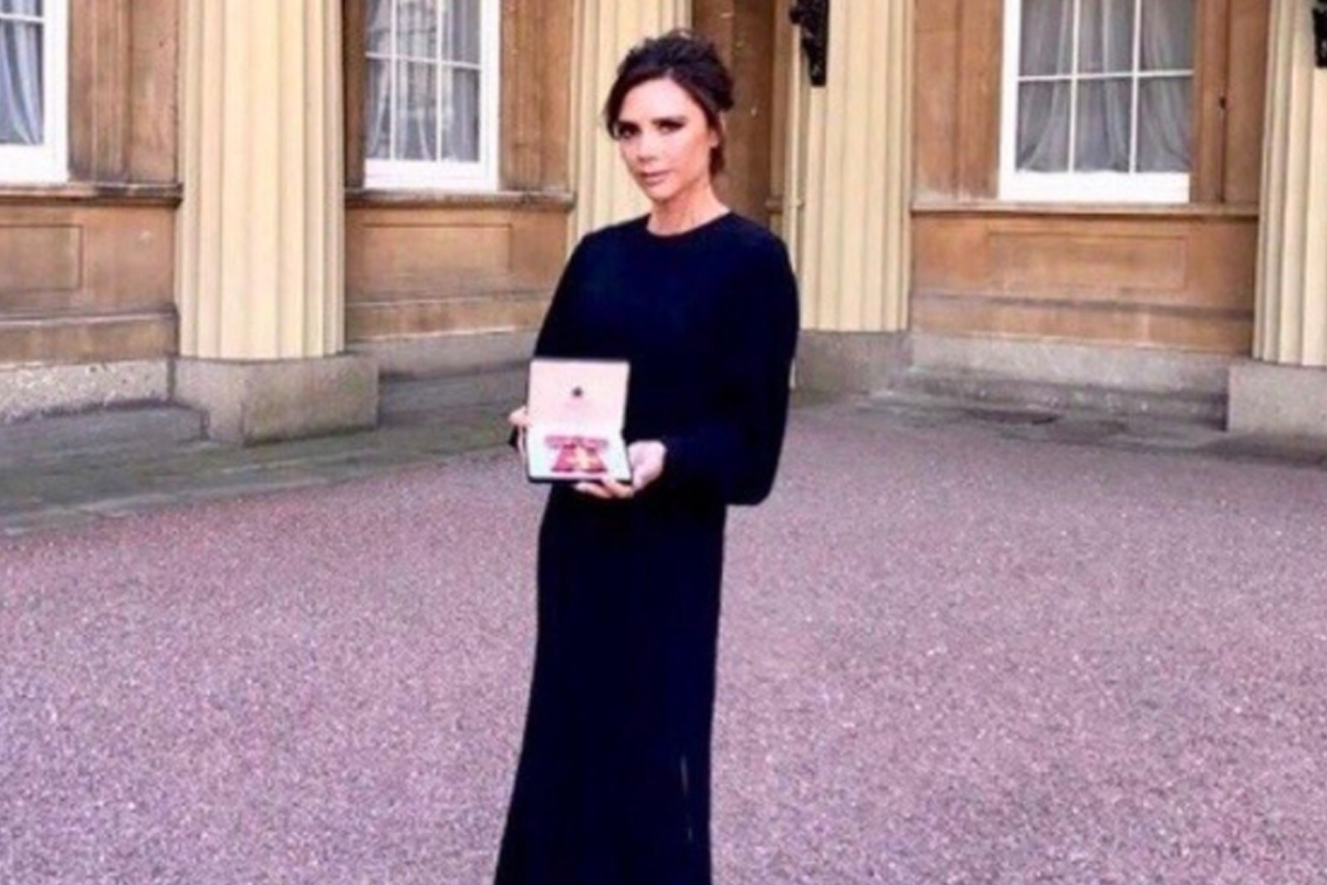 An image of Victoria Beckham at Buckingham palace with her OBE
