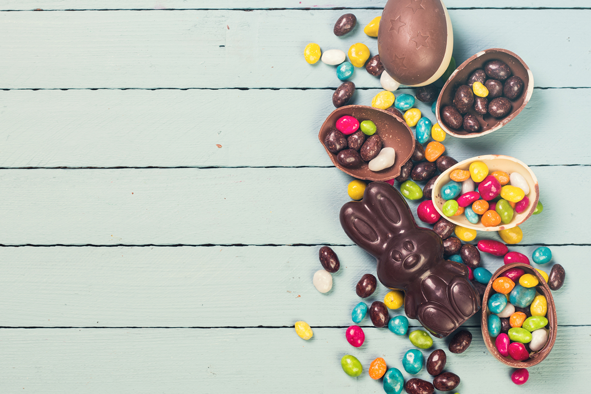 An image of colourful Easter chocolate laid out over a table.