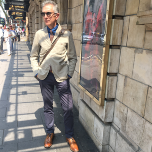 An image of David Evans aka grey fox blog wearing a stylish summer suit and sunglasses in the summer.