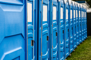 A close up image of a row of chemical toilets at the Glastonbury Festival.