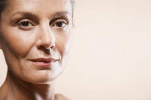 A portrait of a mature woman after rejuvenating her face through facial yoga.