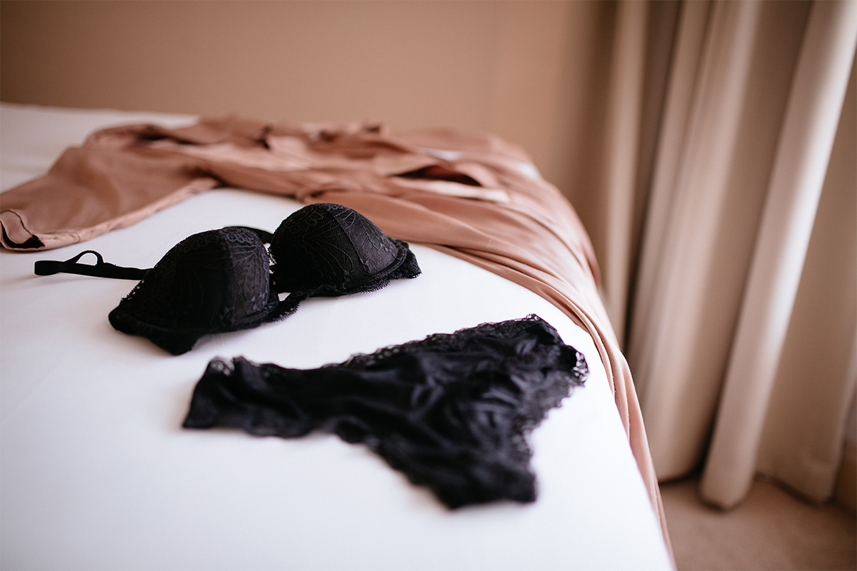 An image of lace underwear on a bed.