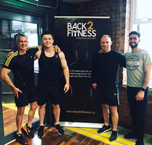 An image of middle aged Bren with the back2fitness team at the gym.