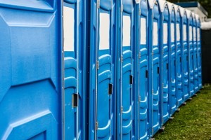 An image of rows of chemical toilets at Glastonbury festival.