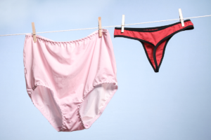 An image of big pants on a washing line next to small pants.