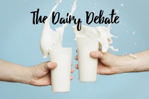 An image of two people clinking their glassess of milk on a blue background with the text superimposed, 'the dairy debate'.