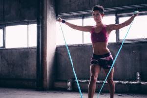 An image of a woman working out with the rejuvage resistance and exercise band.