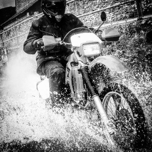 A black and white image of Graham Dodridge on his motorcycle.