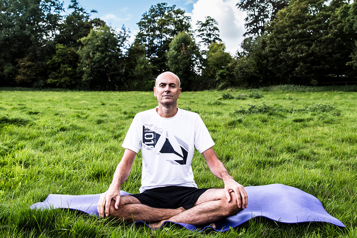 An image of middle aged Paul Baynham practising yoga which helped him over come Crohn's disease