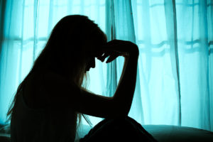 An image of a silhouette of a stressed menopausal woman.