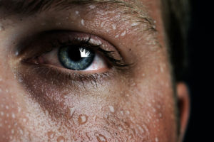 An image of a woman sweating close up.