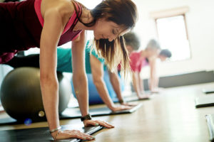 An image of a group of middle aged people exercising at the gym.