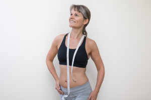 An image of a mature woman who has worked out and lost her excess belly fat.