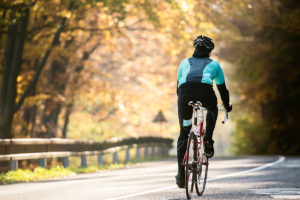 An image of a mature woman cycling.