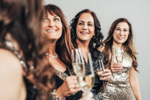 An image of a group of mature woman at a new years party with champagne.