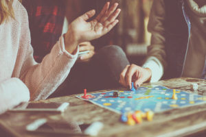 An cropped image of a group of friends playing board games.