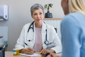 An image of a mature woman at a menopause consultation with her GP.