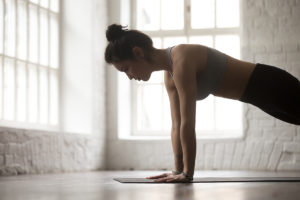 An image of a mature woman doing a plank,