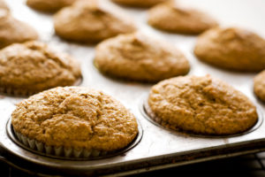 A close up image of a tray of banana muffins.