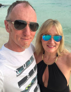 An image of Louise and Kevin on holiday at a beach.