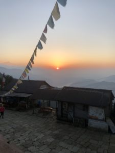 an orange sunset over the mountains in Nepal