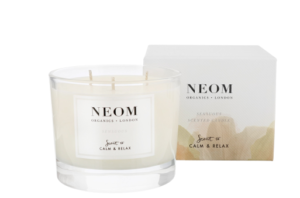 neom candle in a glass jar with butter box packaging