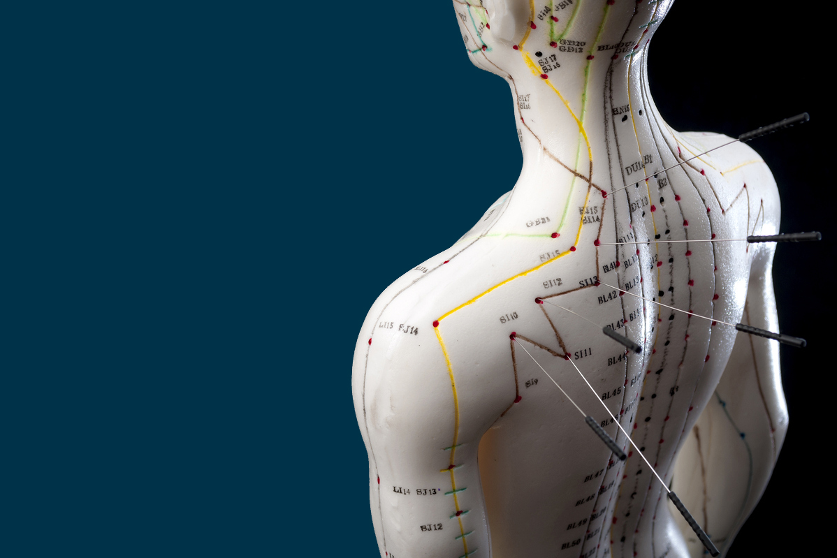 Alternative medicine and east asian healing methods concept with acupuncture dummy model