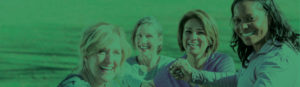 four middle aged vibrant women together and laughing with a green filter wash over the top