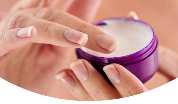 woman hands using face cream