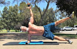 strong mature man doing a side plank effortlessly outside e
