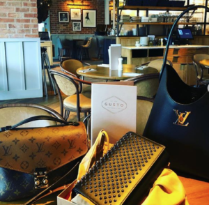stylish designer bags arrange for a photo on a restaurant table