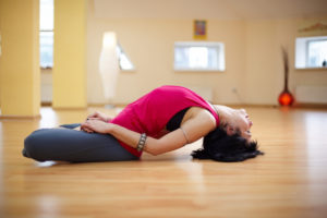 woman in yoga pose in a studio