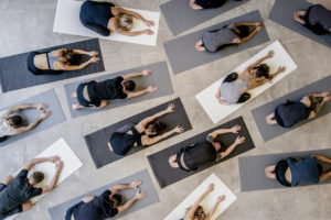 aerial shot of group of women doing your together in a class
