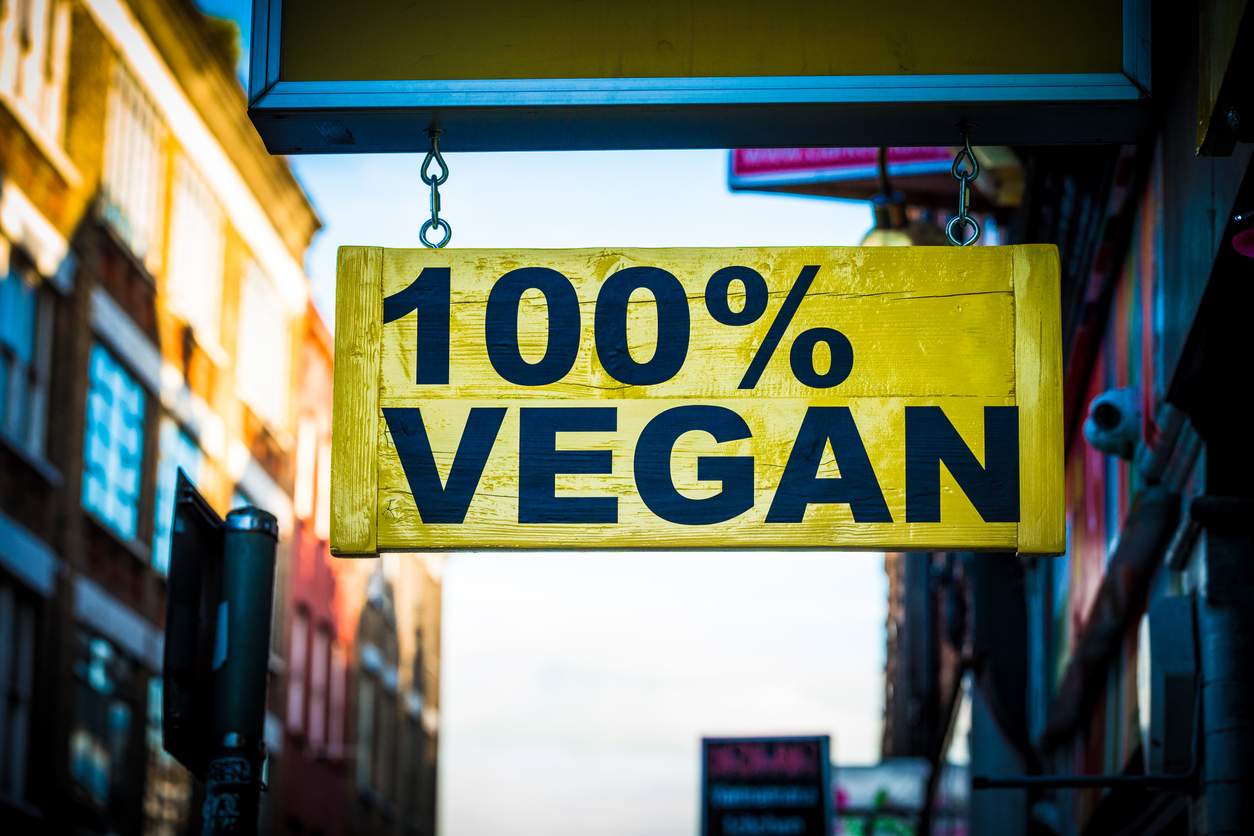 100% vegan yellow sign hanging outside a shop on the highstreet