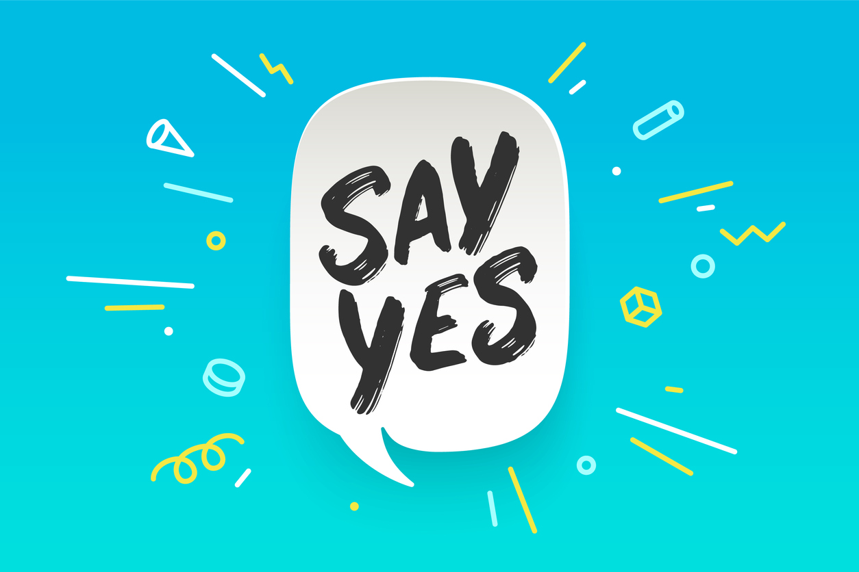 blue illustration with big white speech bubble reading "Say Yes" with illustrative shapes flying out of speech bubble