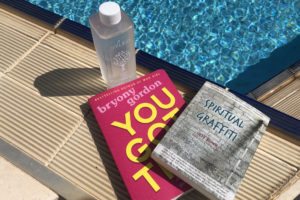 you got this book and spiritual graffiti book poolside with bottle of water