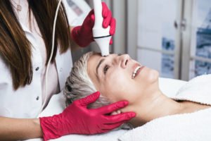 middle aged woman getting a facial skin rejuvenation treatment