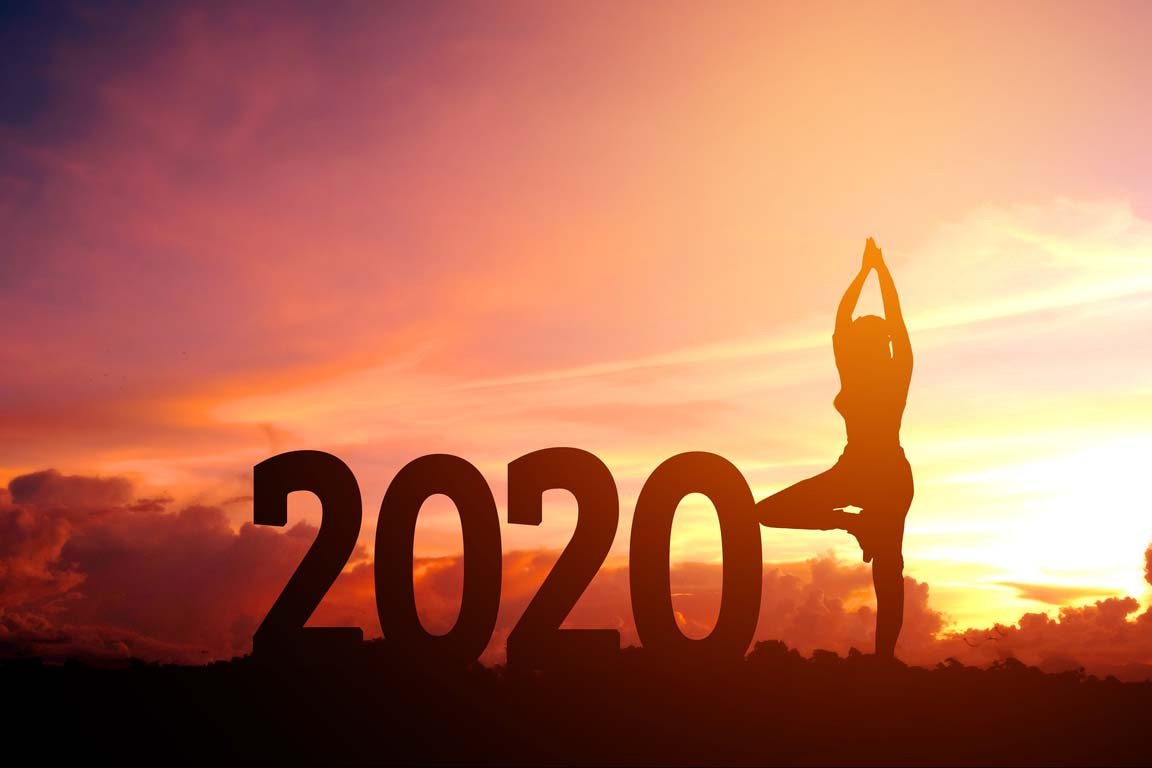 2020 silhouette with woman doing yoga pose alongside