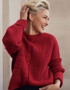 woman in red jumper laughing - over 50 autumn style ideas